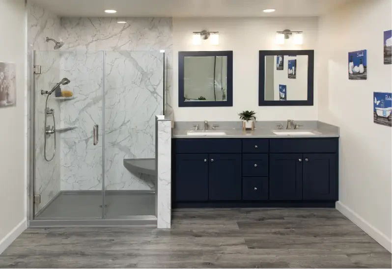 Bathroom with a marble-look walk-in shower and a navy double vanity