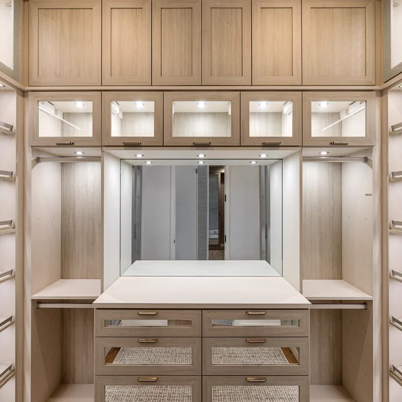 Walk-in closet with wood cabinets and drawers