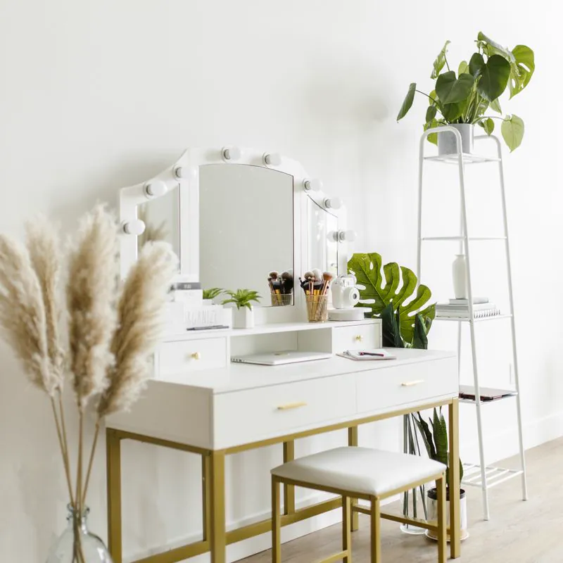 White vanity table with a lighted mirror