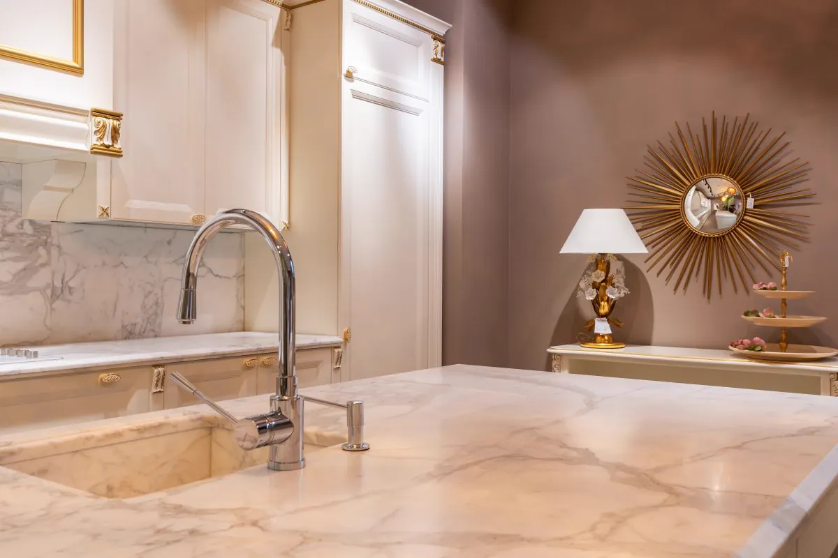 Marble-look kitchen island with an undermount sink and a chrome faucet