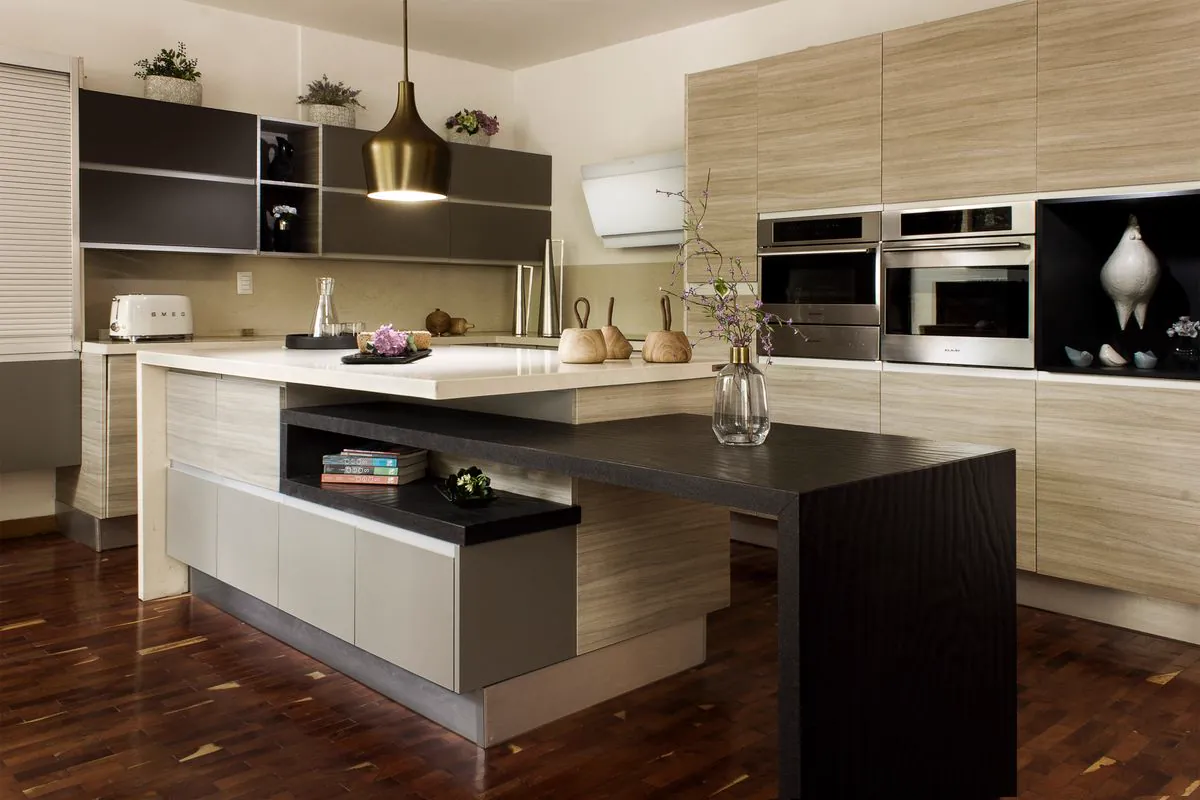 Modern kitchen with wood-look cabinets, a white island and a dark wood breakfast bar
