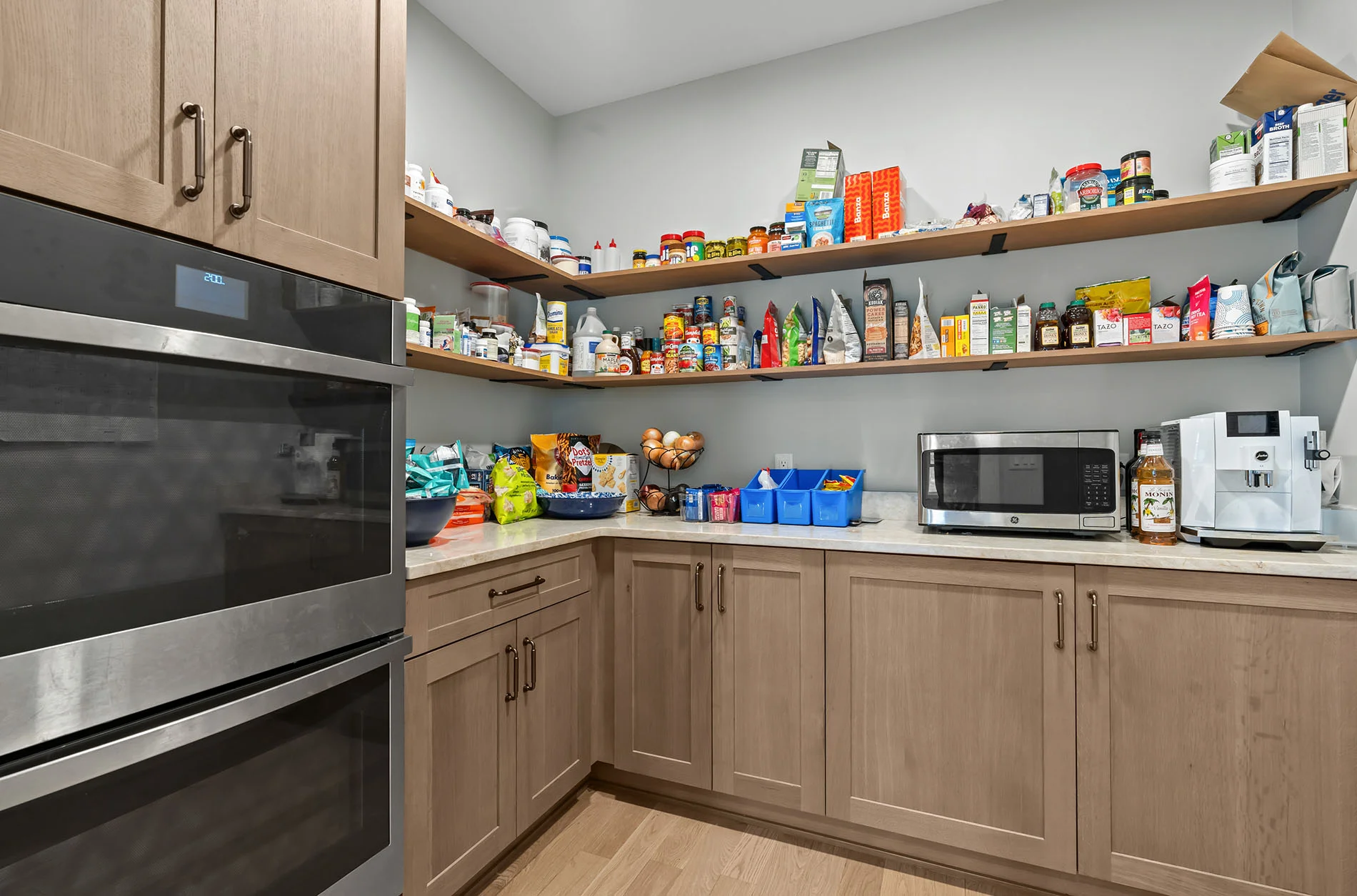 Walk-in pantry with double oven and organized storage